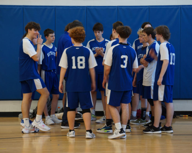 Members of the Boys Volleyball Team conference in the Spring of 2023.